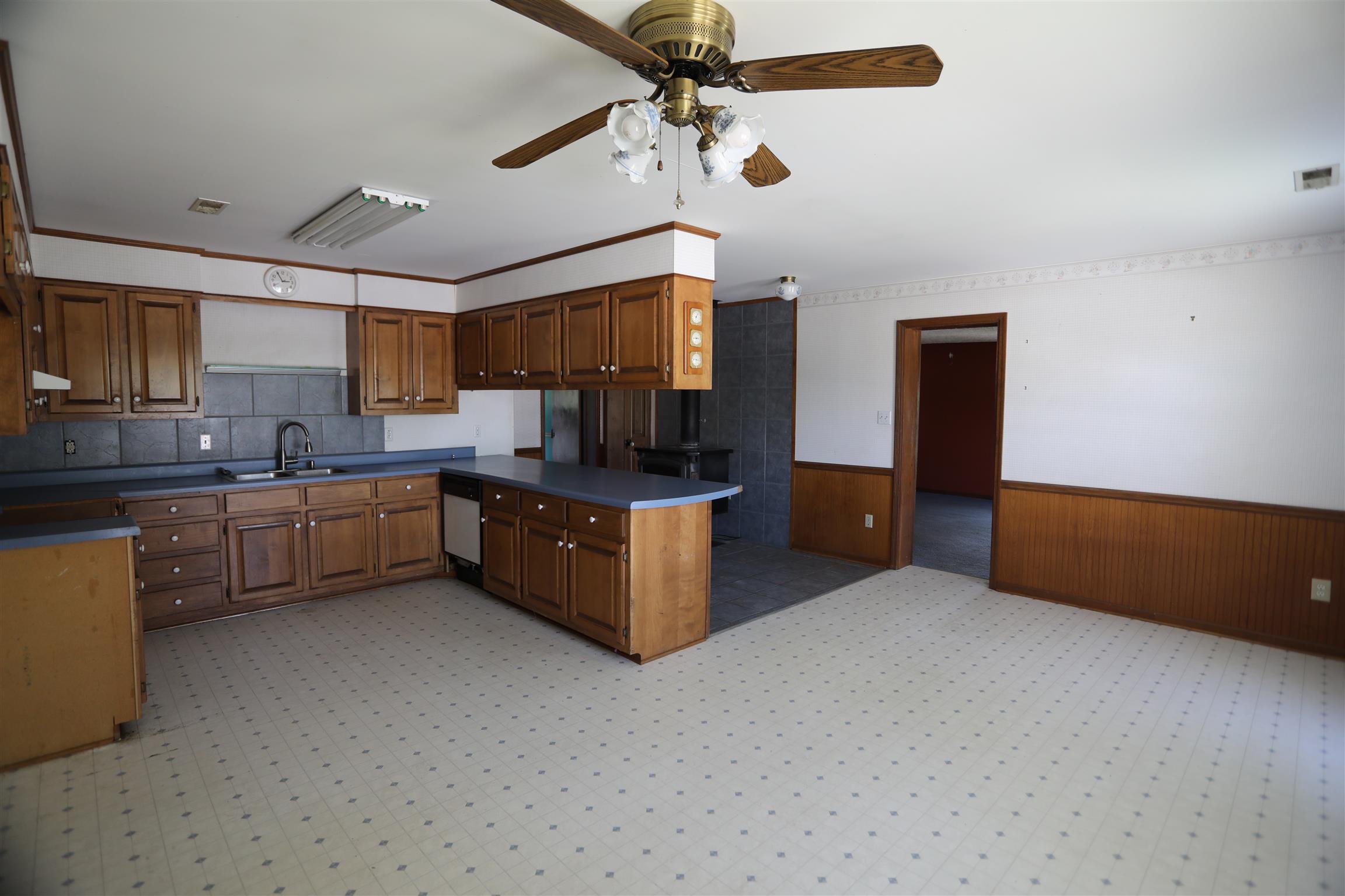 4651 Joe Peay Road Spring Hill, TN 37174 - Photo 14 of 28 a kitchen with stainless steel appliances a sink a stove a refrigerator cabinets and a window