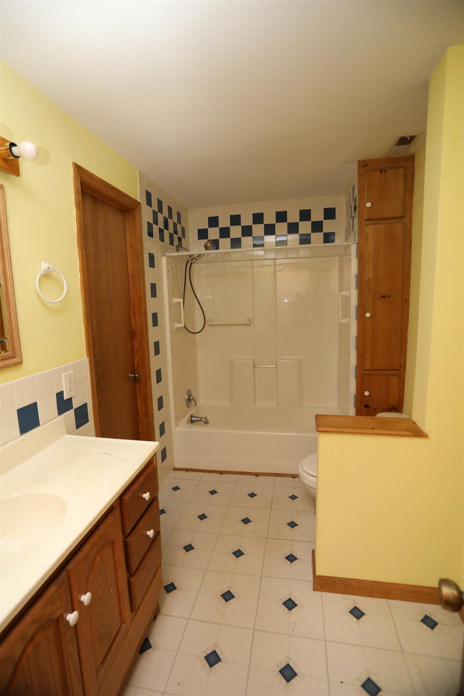 4651 Joe Peay Road Spring Hill, TN 37174 - Photo 19 of 28 a bathroom with a bathtub sink and mirror
