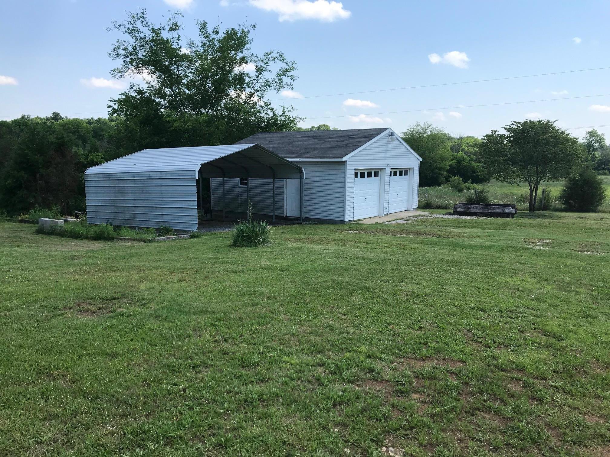 4651 Joe Peay Road Spring Hill, TN 37174 - Photo 25 of 28 a house with huge green field and large trees