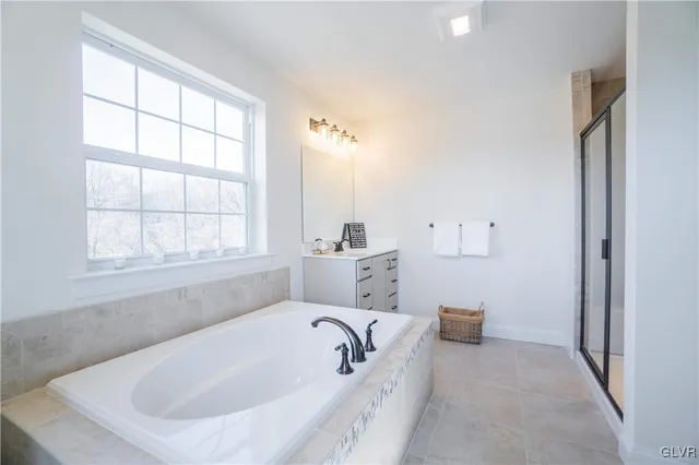 a bathroom with a bathtub and a window