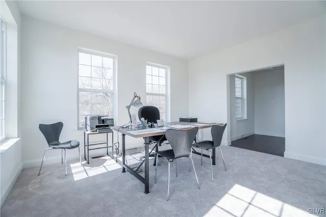 a view of a dining room with furniture and window