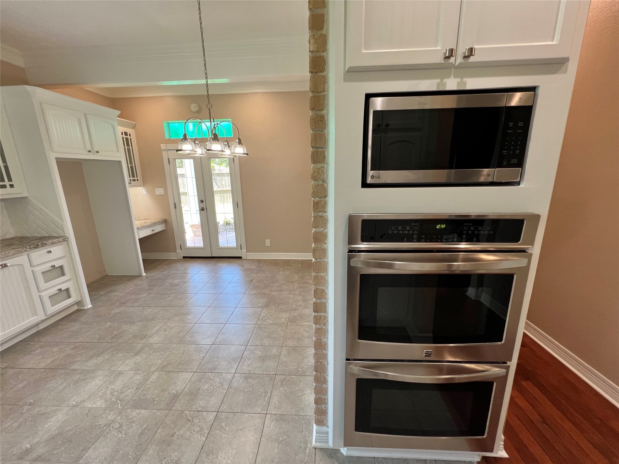 341 Lasso Street Angleton, TX 77515 - Photo 16 of 49 a kitchen with granite countertop a stove and a microwave
