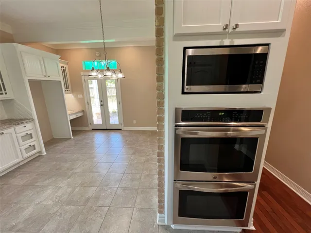 a kitchen with granite countertop a stove and a microwave