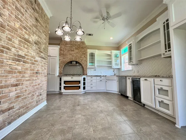 a large kitchen with stainless steel appliances granite countertop a stove and a sink