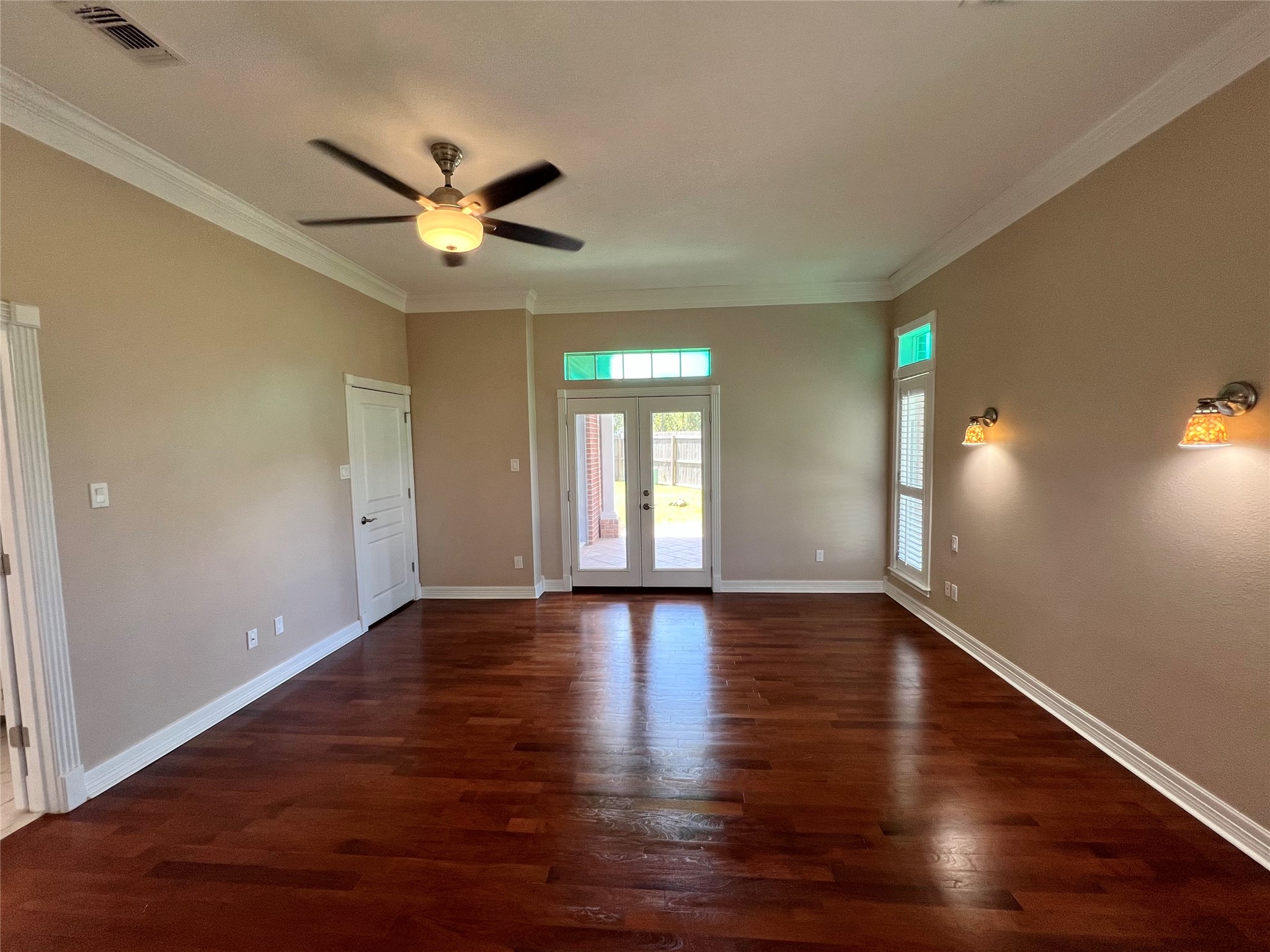 341 Lasso Street Angleton, TX 77515 - Photo 20 of 49 a view of an empty room with window and wooden floor