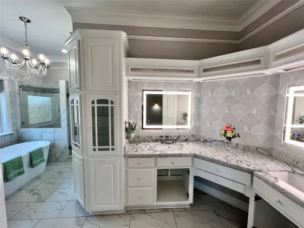 a bathroom with a granite countertop sink a mirror and a shower