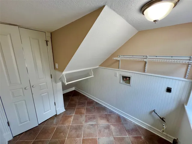 a bathroom with a granite countertop sink a toilet and mirror