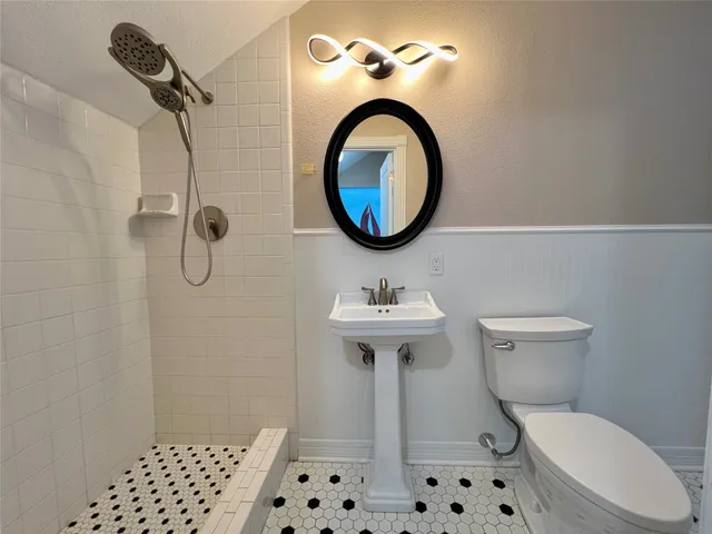 a utility room with granite countertop a sink a stove and cabinets
