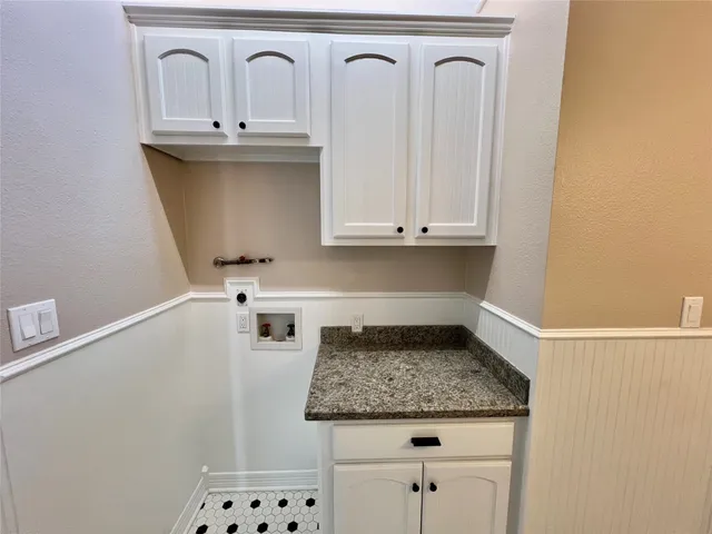 a view of room with wooden floor and a ceiling fan
