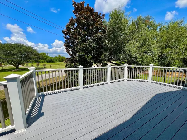 a view of a deck with wooden floor and fence
