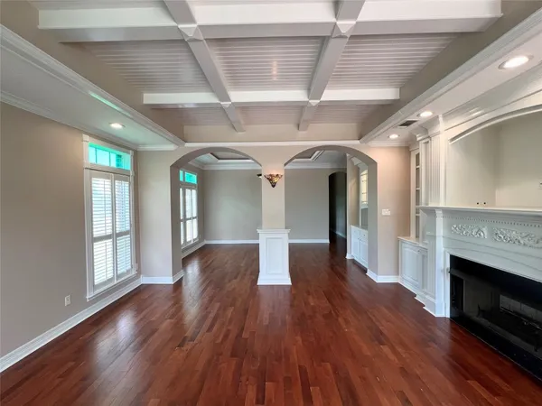 a hallway with wooden floors and fireplace