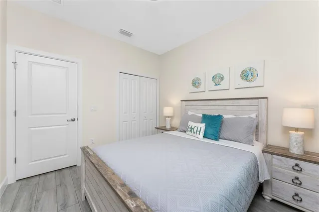 a bedroom with a bed and a night stand