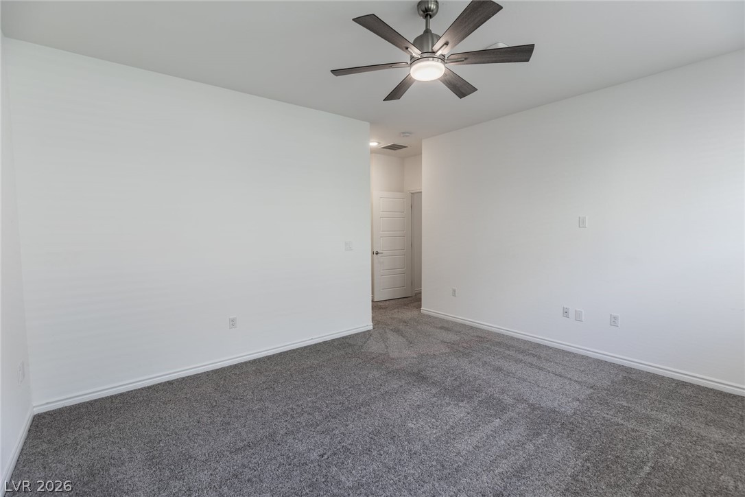 2555 Hampton Road, Unit 8206 Henderson, NV 89052 - Photo 13 of 35 This spacious bedroom offers ample space for relaxation and features a ceiling fan for comfort.
