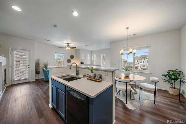 a kitchen with a table chairs and wooden floor