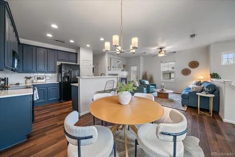 a kitchen with kitchen island a dining table and chairs