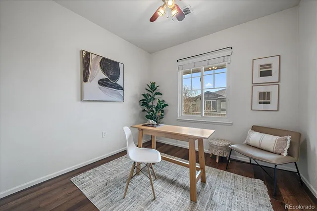 a view of a workspace with furniture and a window