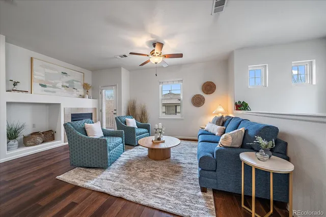 a living room with furniture and a fireplace