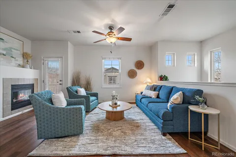 a living room with furniture and a fireplace