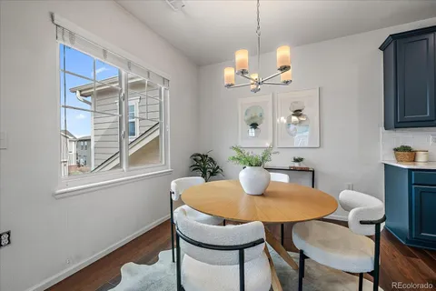 a dining room with furniture a window and wooden floor