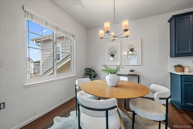 a dining room with furniture a window and wooden floor