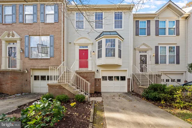 a front view of a residential apartment building with a yard