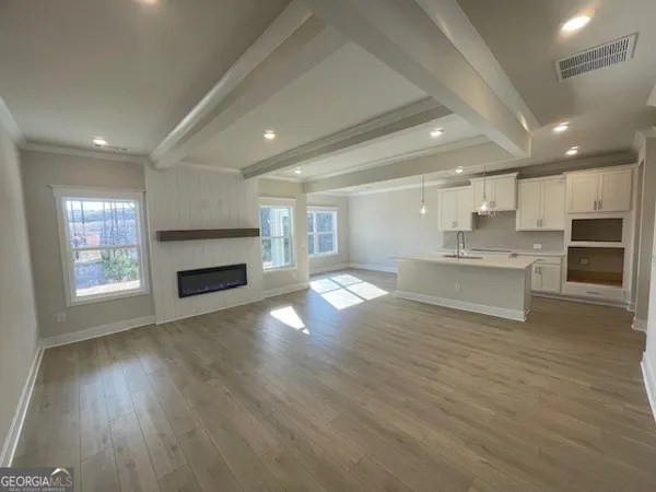 an empty room with windows and fireplace