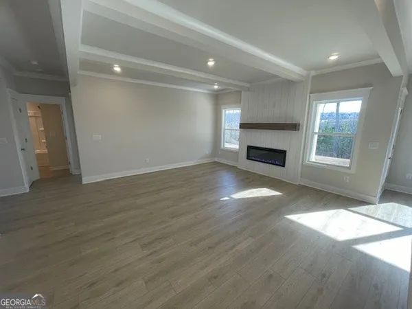a view of staircase with wooden floor and white walls