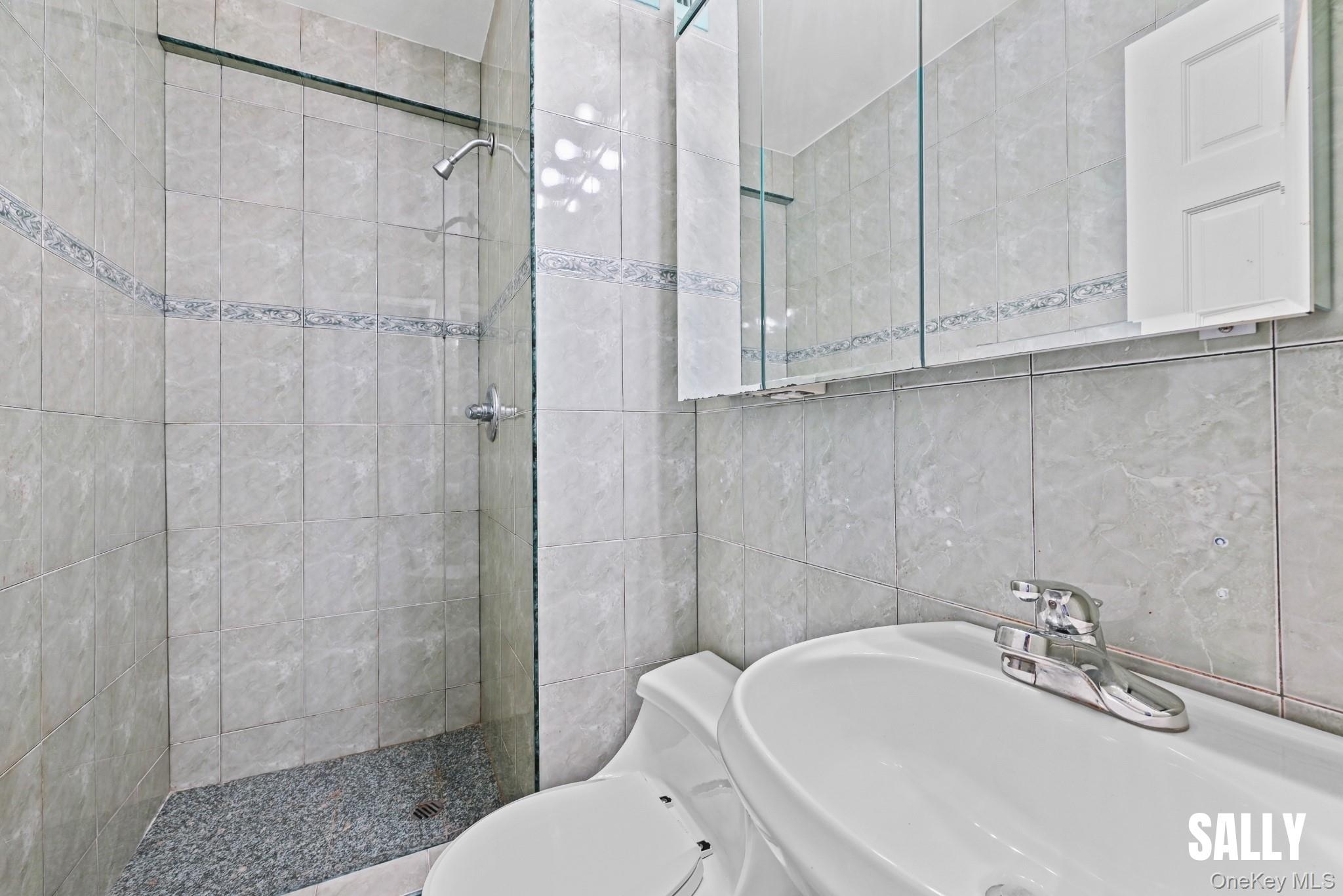 138-10 Franklin Avenue, Unit 12A Queens, NY 11355 - Photo 11 of 20 a bathroom with a sink a toilet and shower