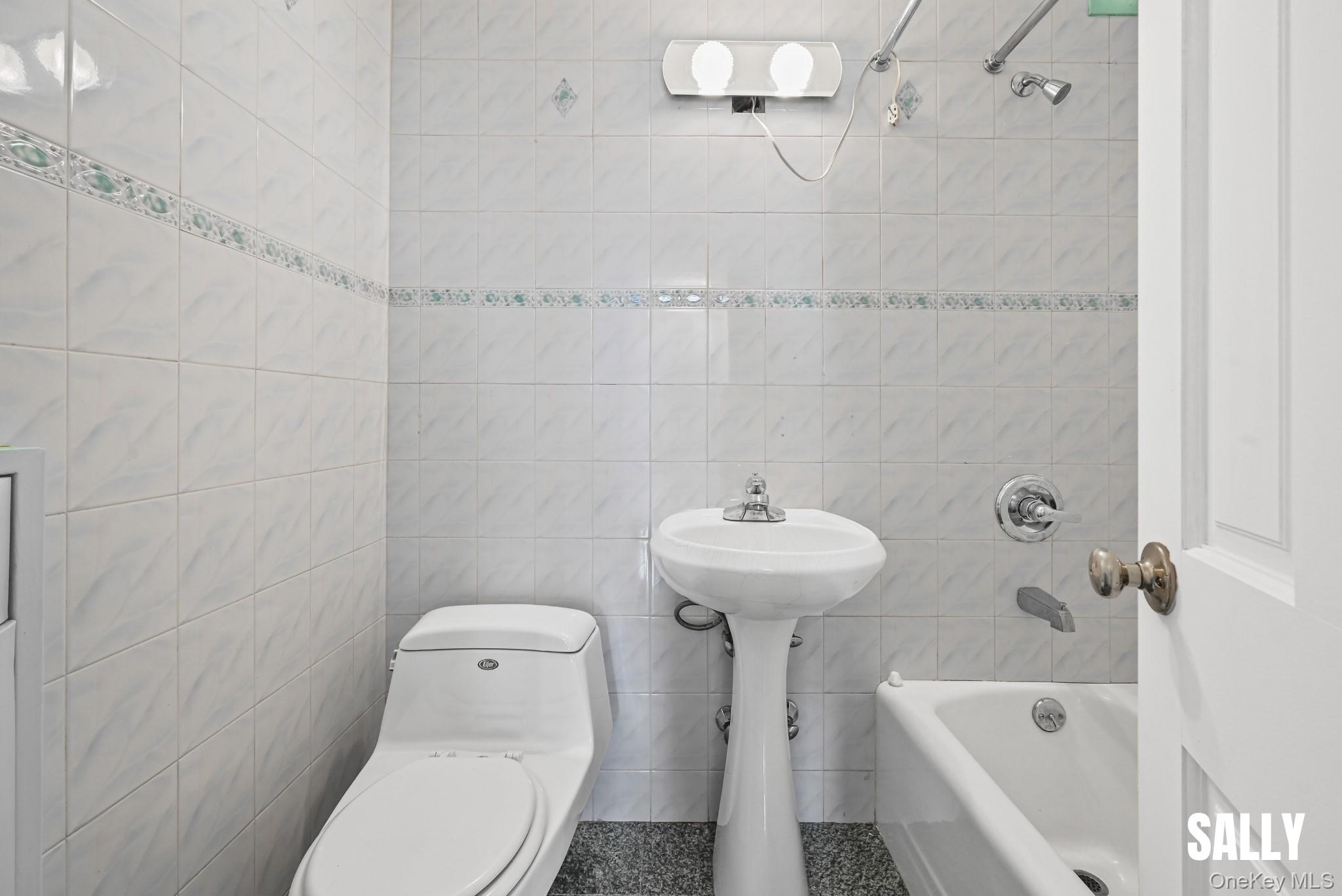 138-10 Franklin Avenue, Unit 12A Queens, NY 11355 - Photo 8 of 20 a bathroom with a sink a toilet and bathtub