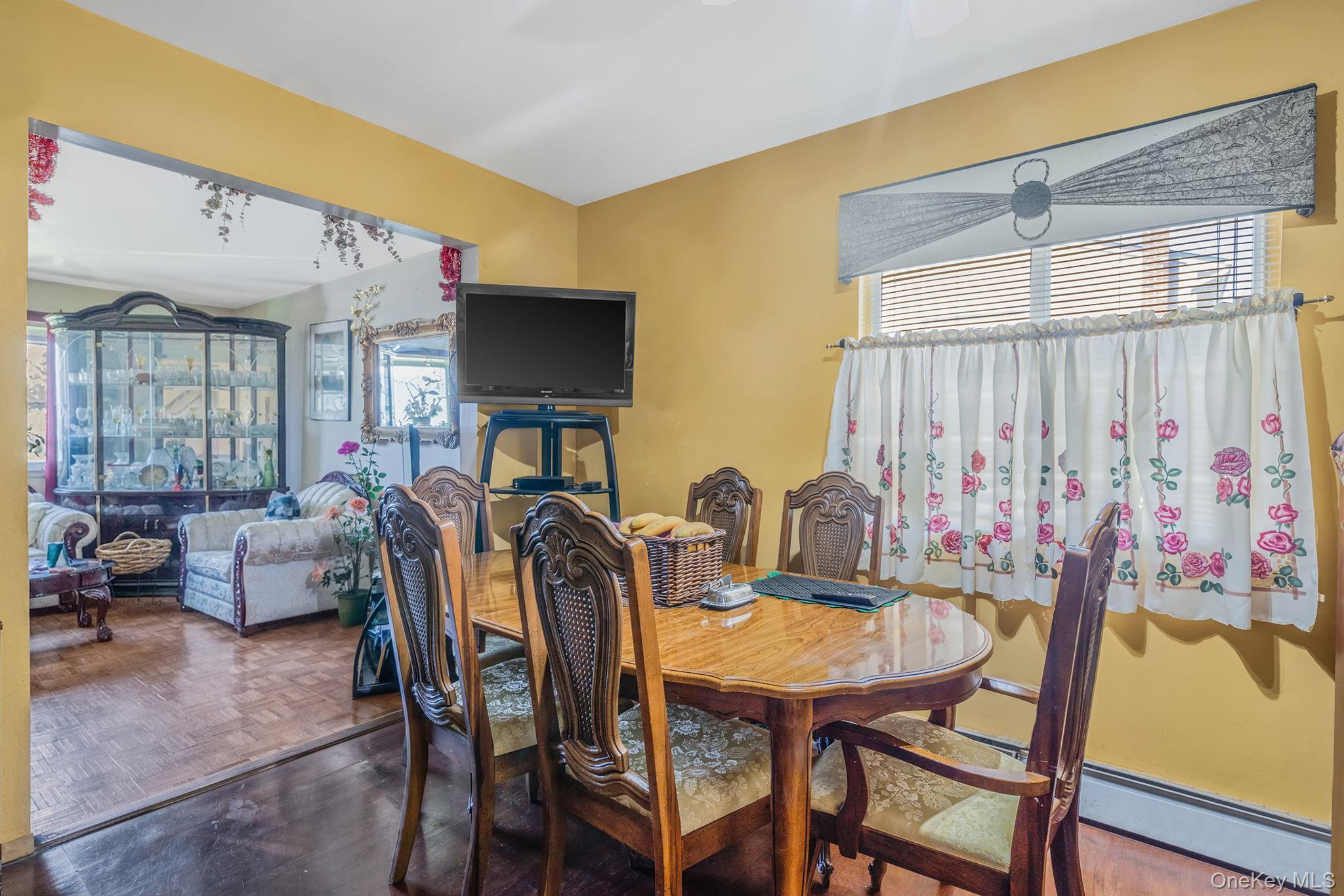 1169 Little E Neck Road West Babylon, NY 11704 - Photo 8 of 28 a view of a dining room with furniture and window