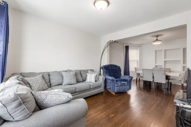 a living room with furniture rug and wooden floor