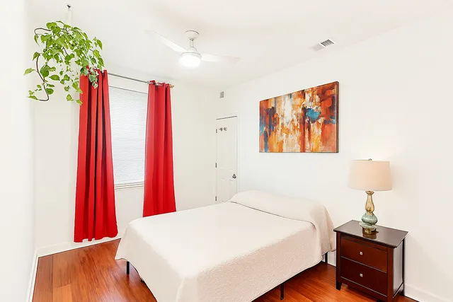 a bed room with a bed and a wooden floor