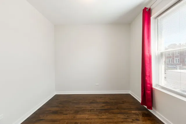 a view of a room with wooden floor and cabinet