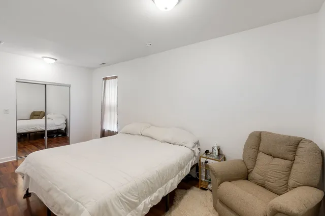 a bedroom with a bed and a mirror