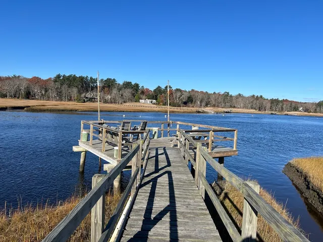 a view of a roof deck with wooden floor and lake view