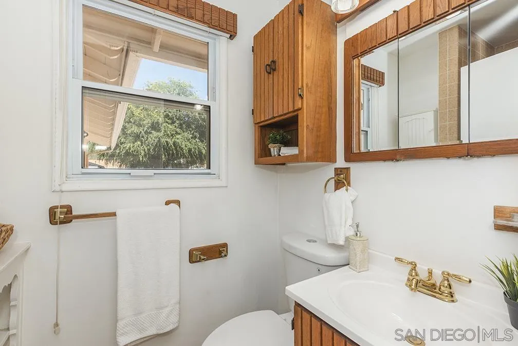 13811 Tobiasson Road Poway, CA 92064 - Photo 17 of 49 a bathroom with a sink a toilet and a mirror