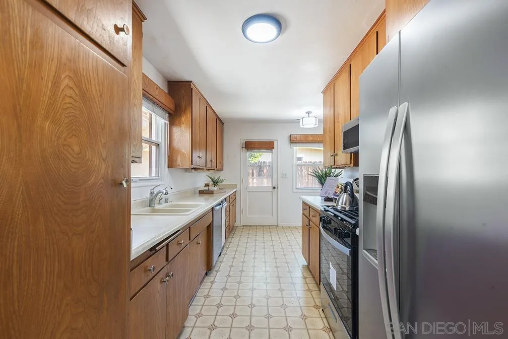 13811 Tobiasson Road Poway, CA 92064 - Photo 30 of 49 a kitchen with stainless steel appliances a sink stove and refrigerator