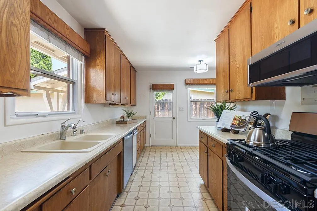 13811 Tobiasson Road Poway, CA 92064 - Photo 31 of 49 a kitchen with a sink stove top oven and cabinets