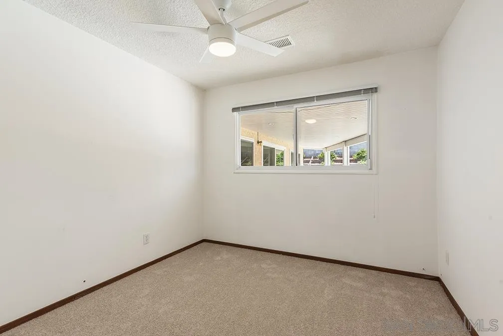 13811 Tobiasson Road Poway, CA 92064 - Photo 42 of 49 an empty room with a window and a fan