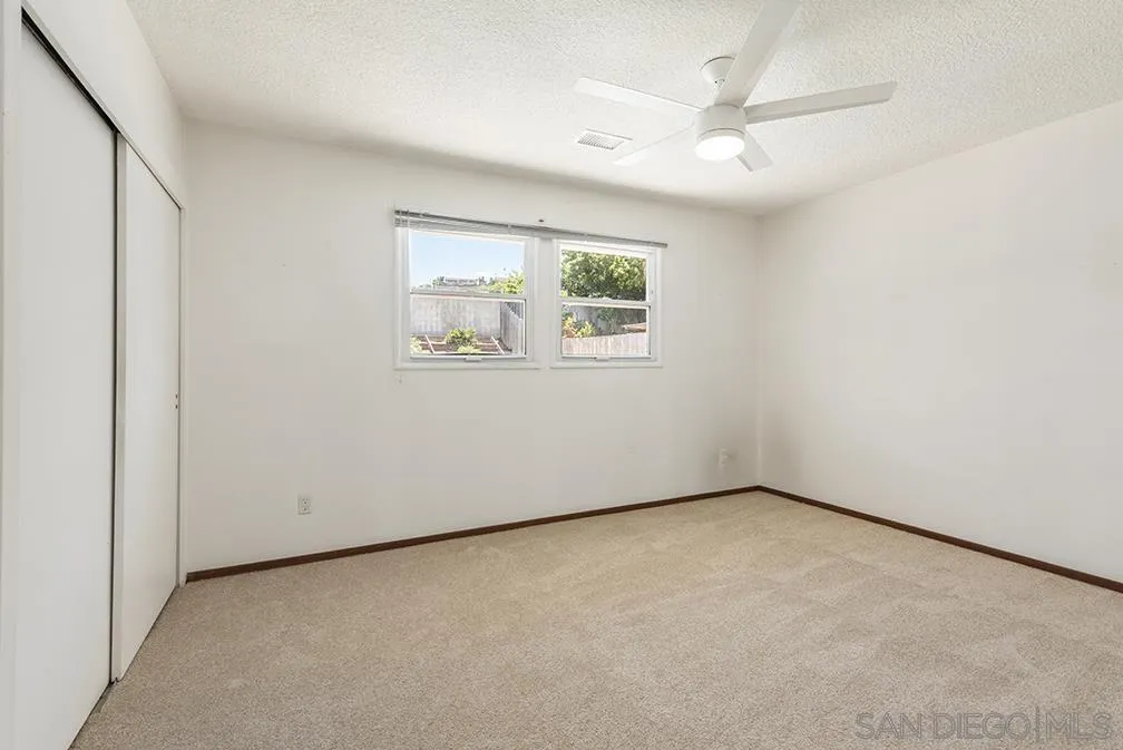 13811 Tobiasson Road Poway, CA 92064 - Photo 44 of 49 an empty room with a window and a ceiling fan