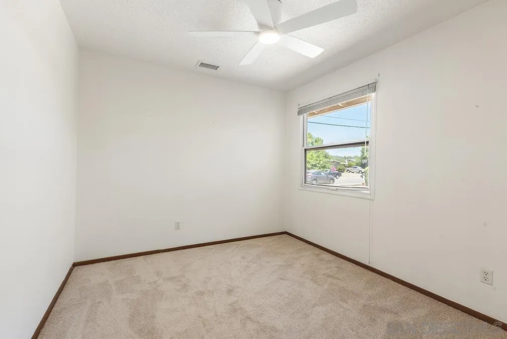 13811 Tobiasson Road Poway, CA 92064 - Photo 45 of 49 an empty room with a window and ceiling fan