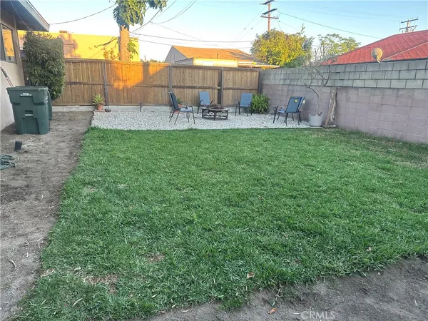 a view of backyard with a table and chairs