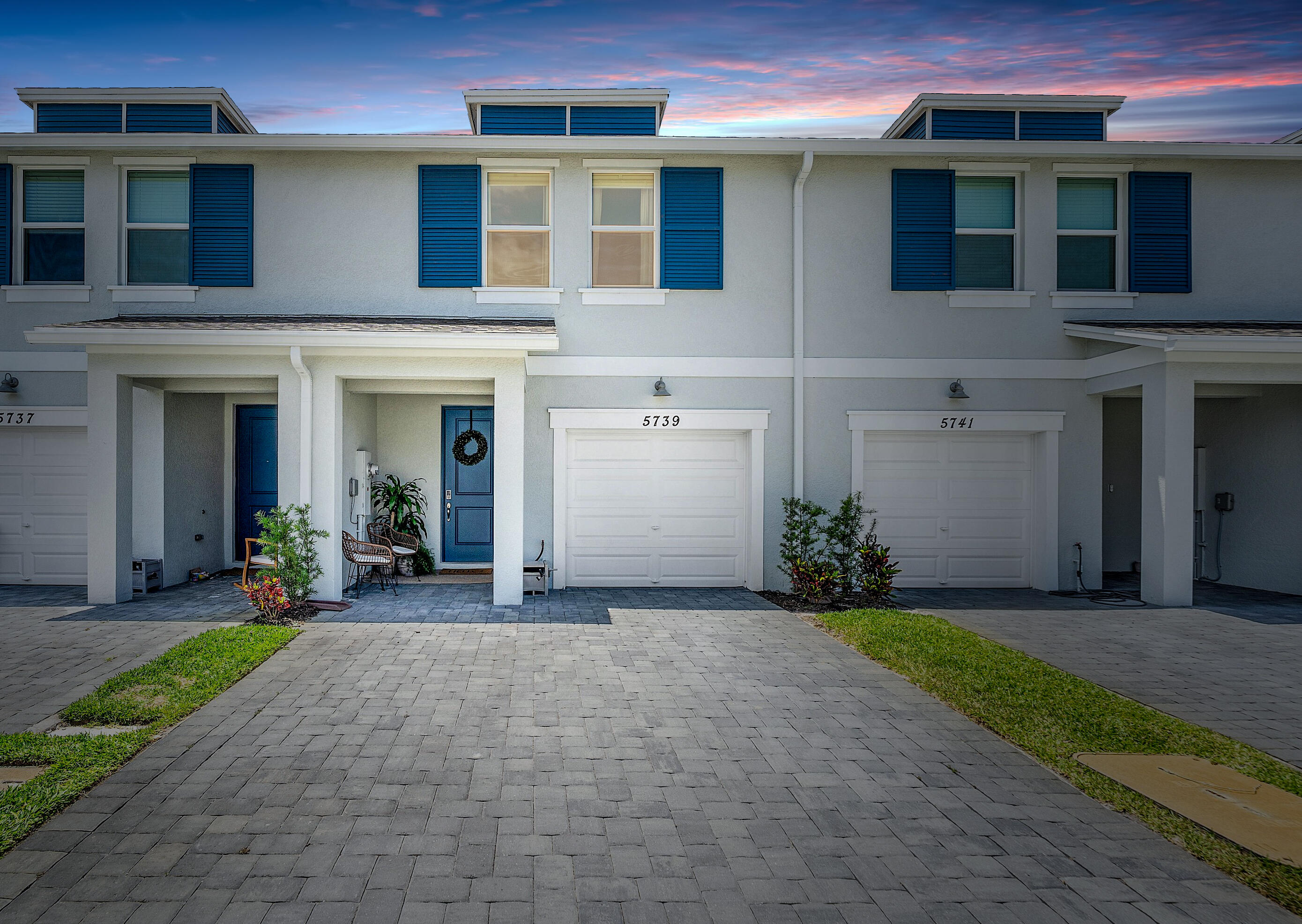 5739 Southeast Edgewater Circle Stuart, FL 34997 - Photo 1 of 29 a front view of a house with a yard and garage