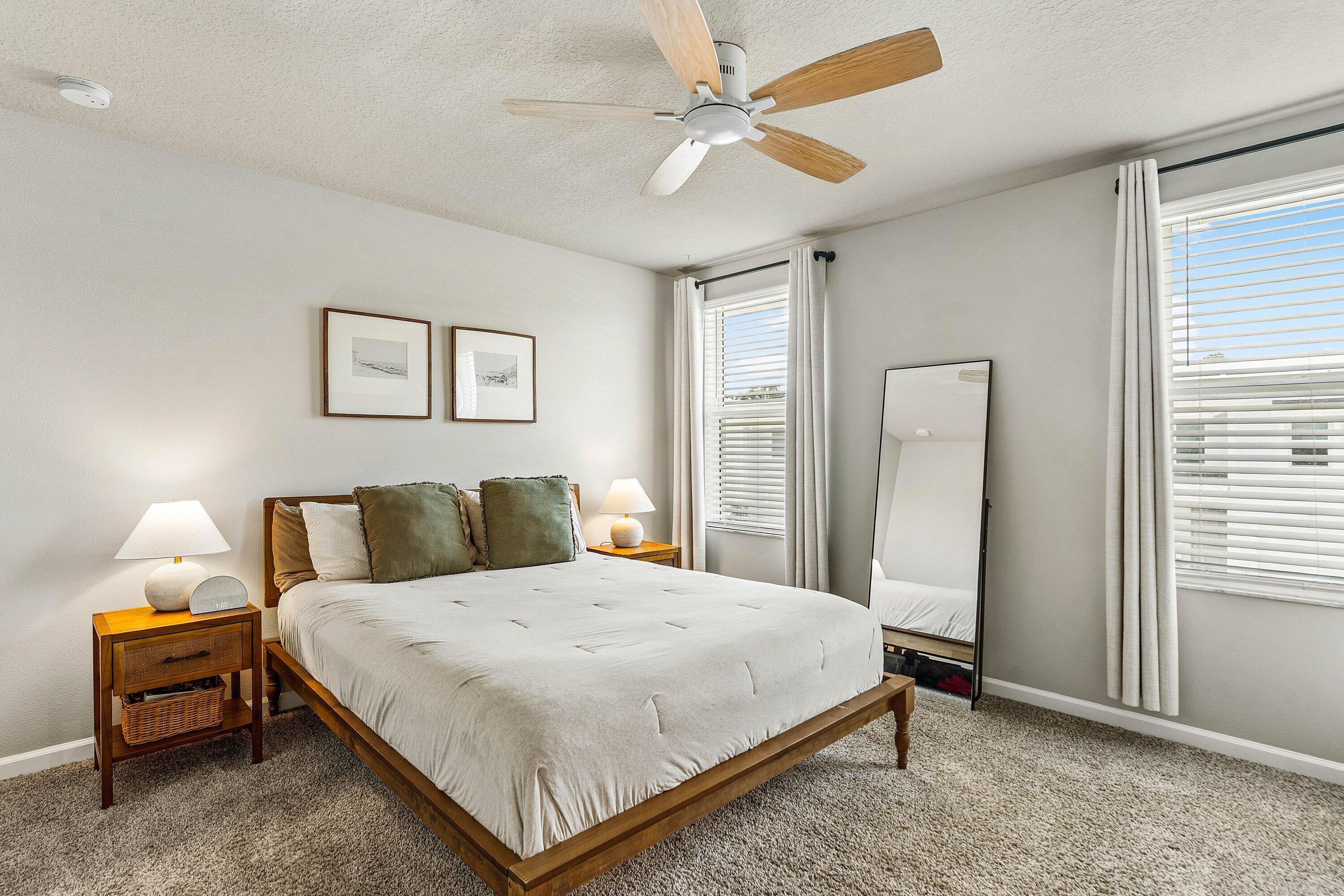 5739 Southeast Edgewater Circle Stuart, FL 34997 - Photo 14 of 29 a bedroom with a bed and a chandelier