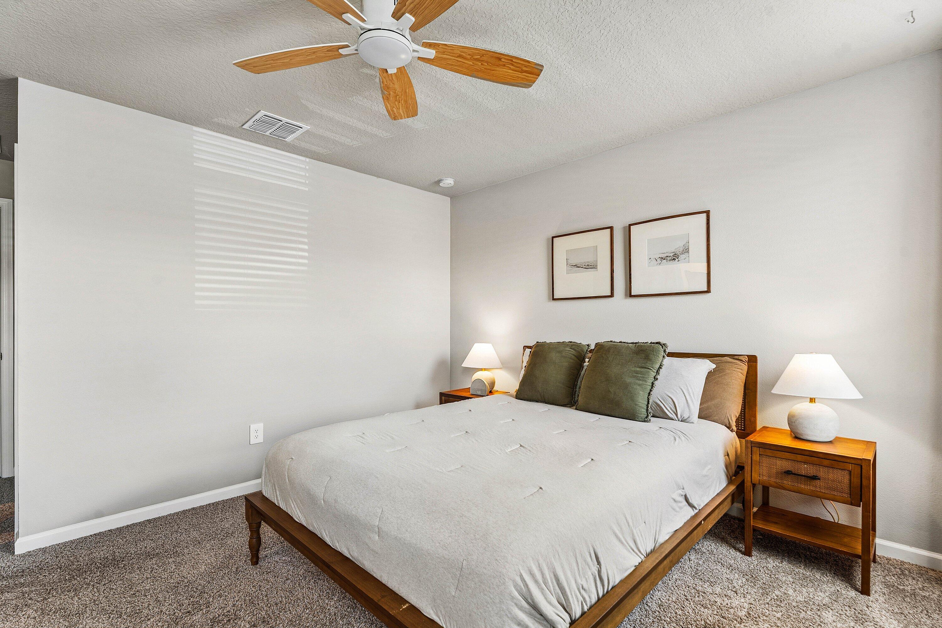 5739 Southeast Edgewater Circle Stuart, FL 34997 - Photo 15 of 29 a bedroom with a bed and a chandelier