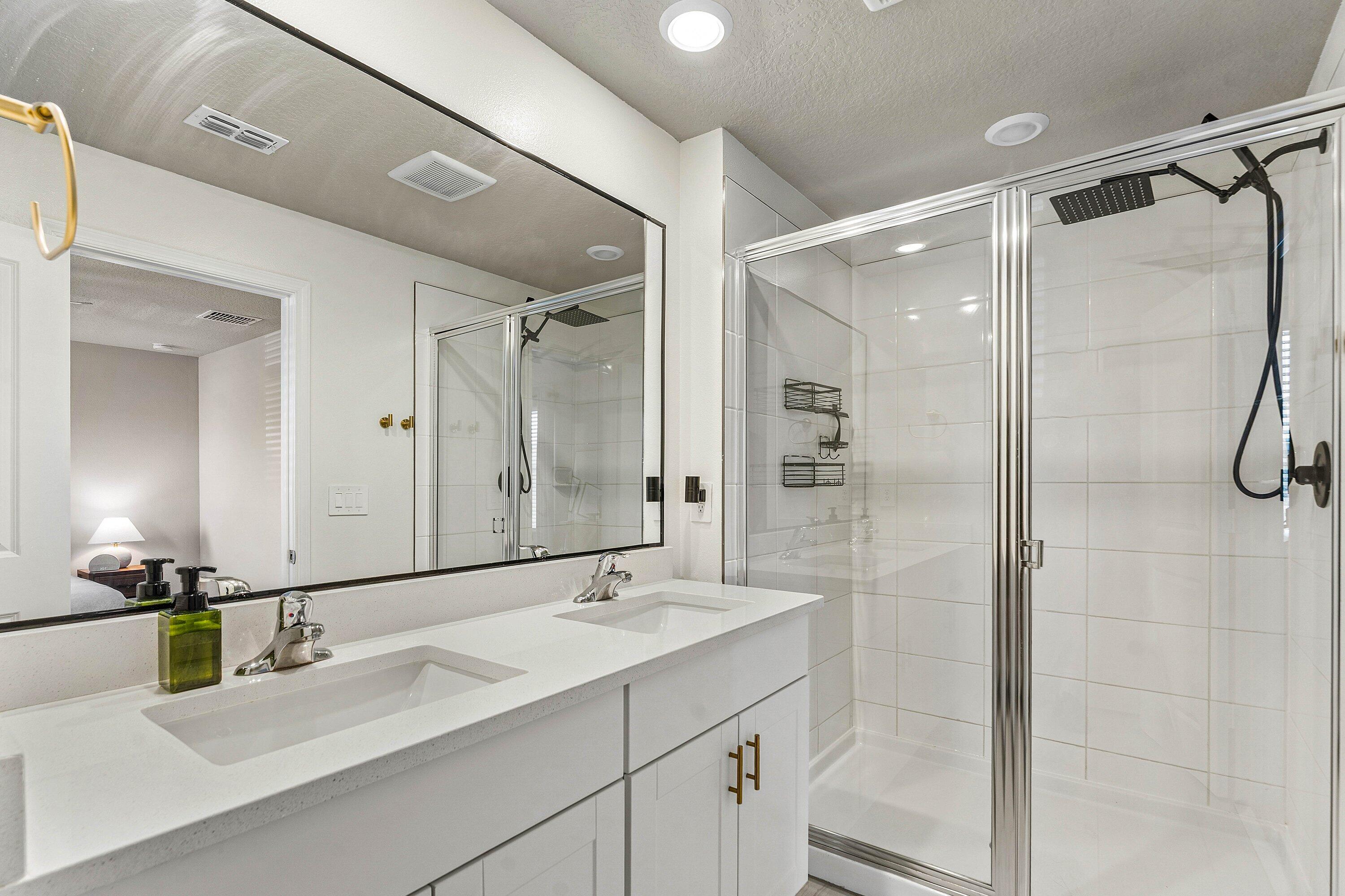 5739 Southeast Edgewater Circle Stuart, FL 34997 - Photo 17 of 29 a bathroom with a double vanity sink mirror double and shower