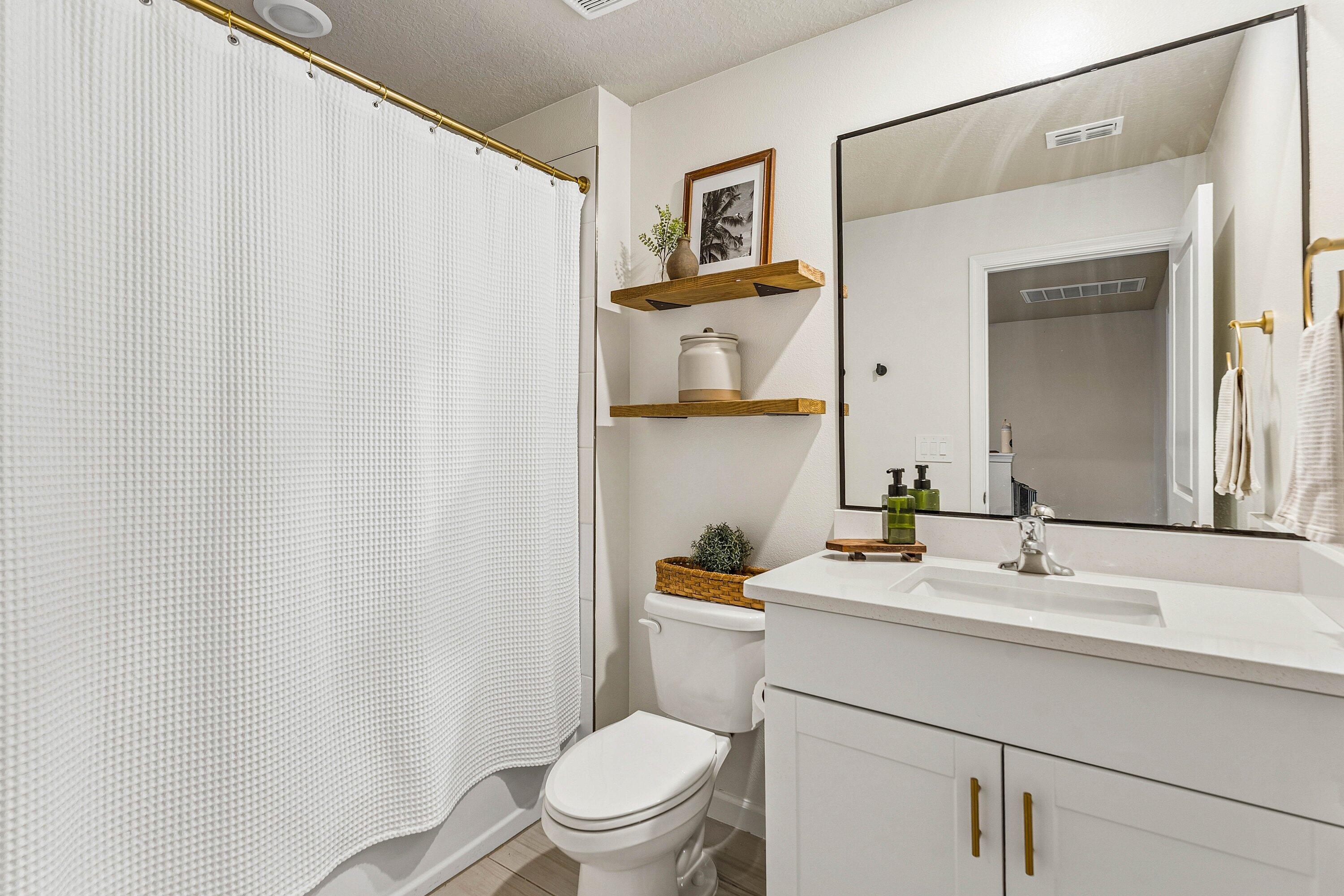 5739 Southeast Edgewater Circle Stuart, FL 34997 - Photo 19 of 29 a bathroom with a sink a toilet and a mirror