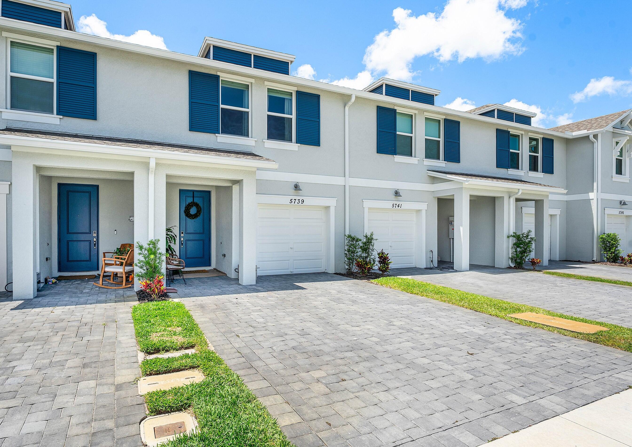 5739 Southeast Edgewater Circle Stuart, FL 34997 - Photo 2 of 29 a front view of a house with swimming pool and porch