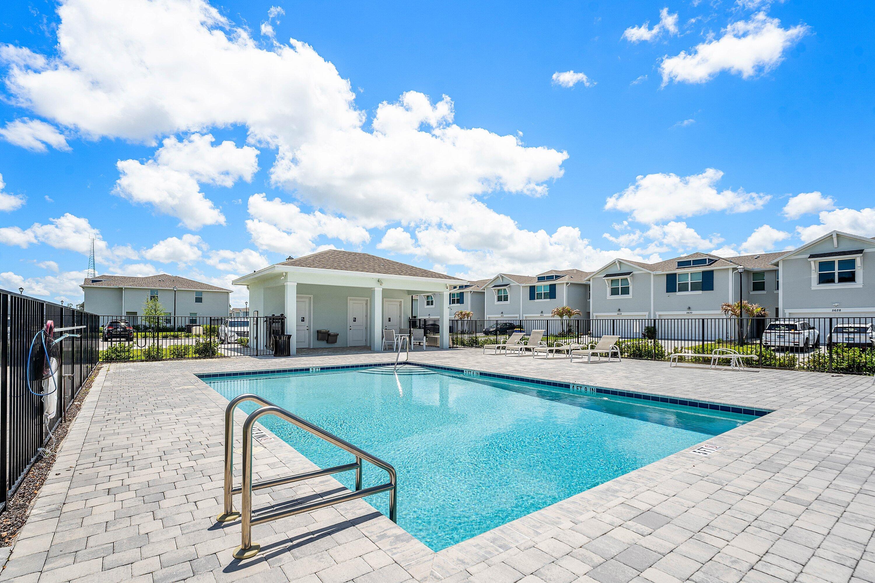 5739 Southeast Edgewater Circle Stuart, FL 34997 - Photo 25 of 29 a view of a house with swimming pool and sitting area
