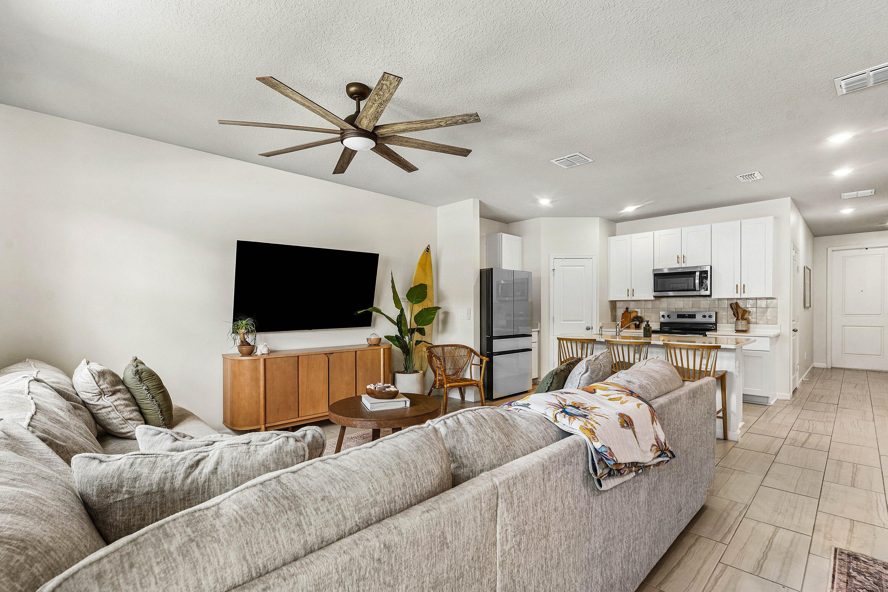 5739 Southeast Edgewater Circle Stuart, FL 34997 - Photo 6 of 29 a living room with furniture and a flat screen tv